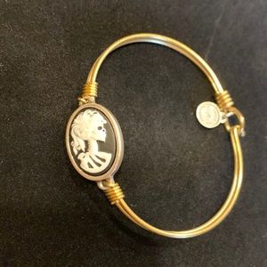 Gold bangle with black and white skull cameo